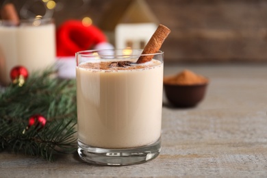 Photo of Delicious Christmas liqueur on wooden table, closeup