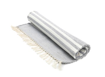 Photo of Stylish rolled light grey rug isolated on white. Interior accessory