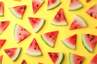 Photo of Flat lay composition with slices of watermelon on color background