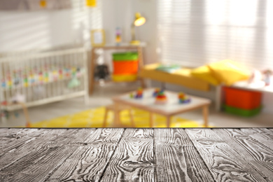 Image of Empty wooden table in baby room interior