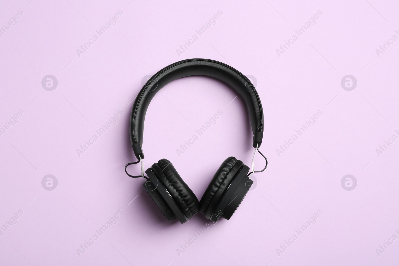 Photo of Stylish headphones on color background, top view