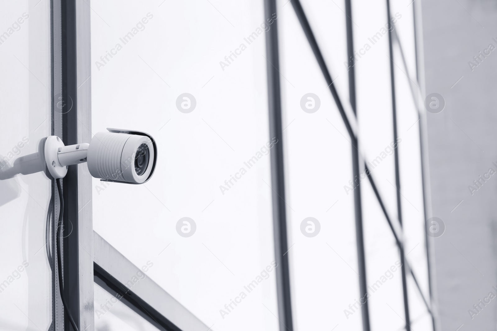 Photo of Modern security CCTV camera on wall outdoors