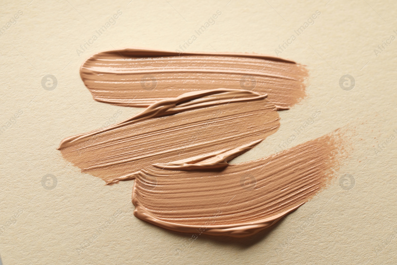 Photo of Sample of liquid skin foundation on beige background