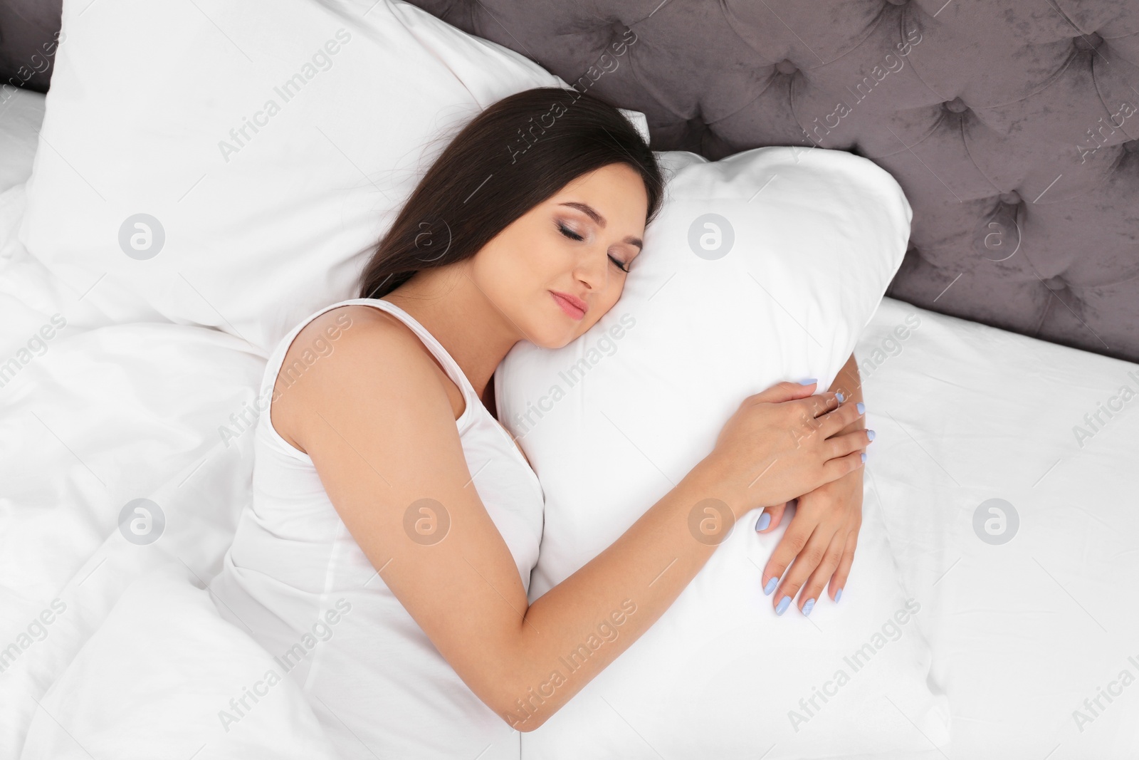 Photo of Beautiful pregnant woman sleeping on comfortable pillow in bed at home