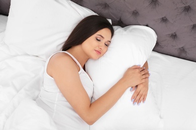 Beautiful pregnant woman sleeping on comfortable pillow in bed at home