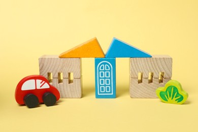 Photo of Set of wooden toys on yellow background. Children's development