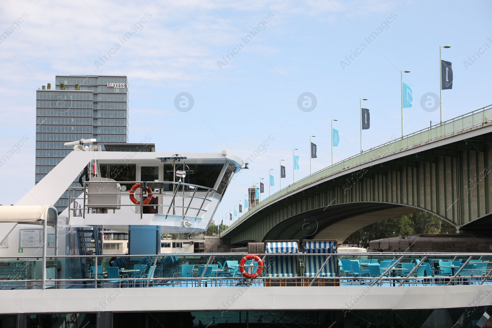 Photo of Cologne, Germany - August 28, 2022: Picturesque view of a modern bridge over river and ferry boat