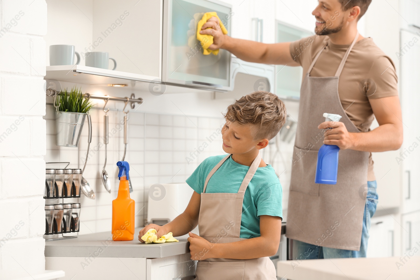Photo of Dad and son cleaning in kitchen together