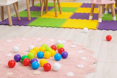 Photo of Bright toy balls on floor in kindergarten