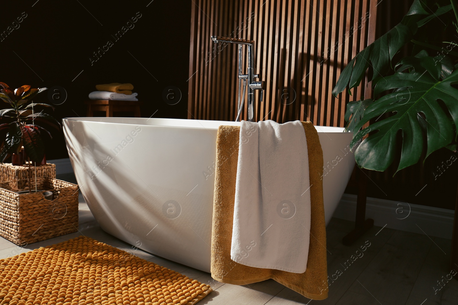 Photo of Cozy bathroom interior with stylish ceramic tub