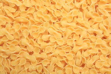 Photo of Raw farfalle pasta as background, top view