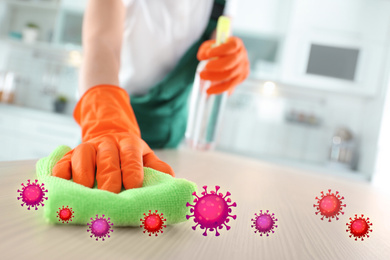 Image of Cleaning vs viruses. Woman washing table with sponge and disinfecting solution