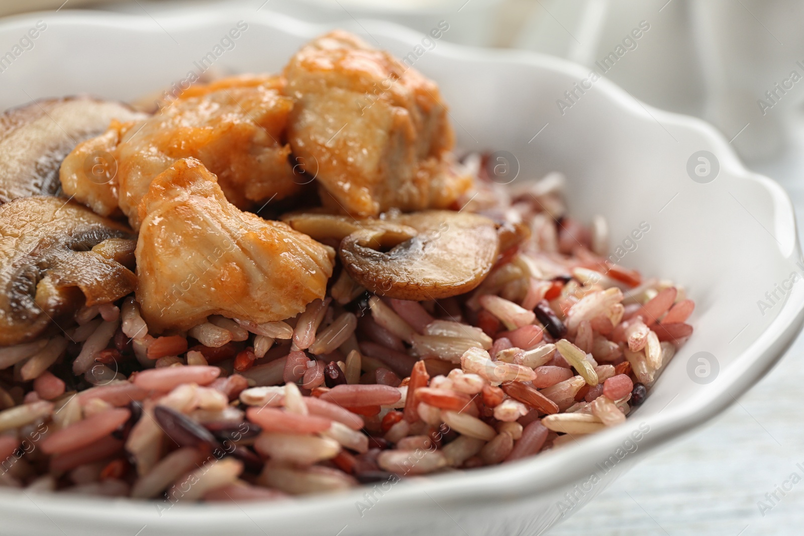 Photo of Delicious brown rice in bowl, closeup view