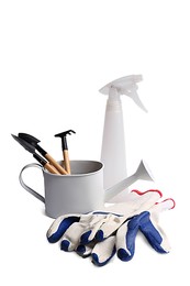 Photo of Gardening gloves, tools and watering can on white background