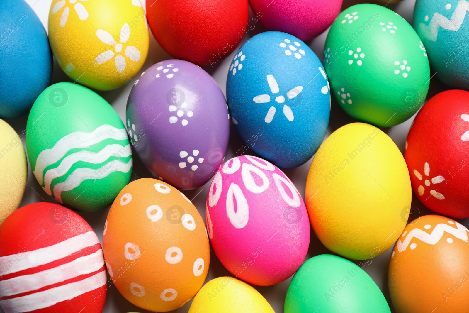 Photo of Colorful Easter eggs with different patterns as background, top view