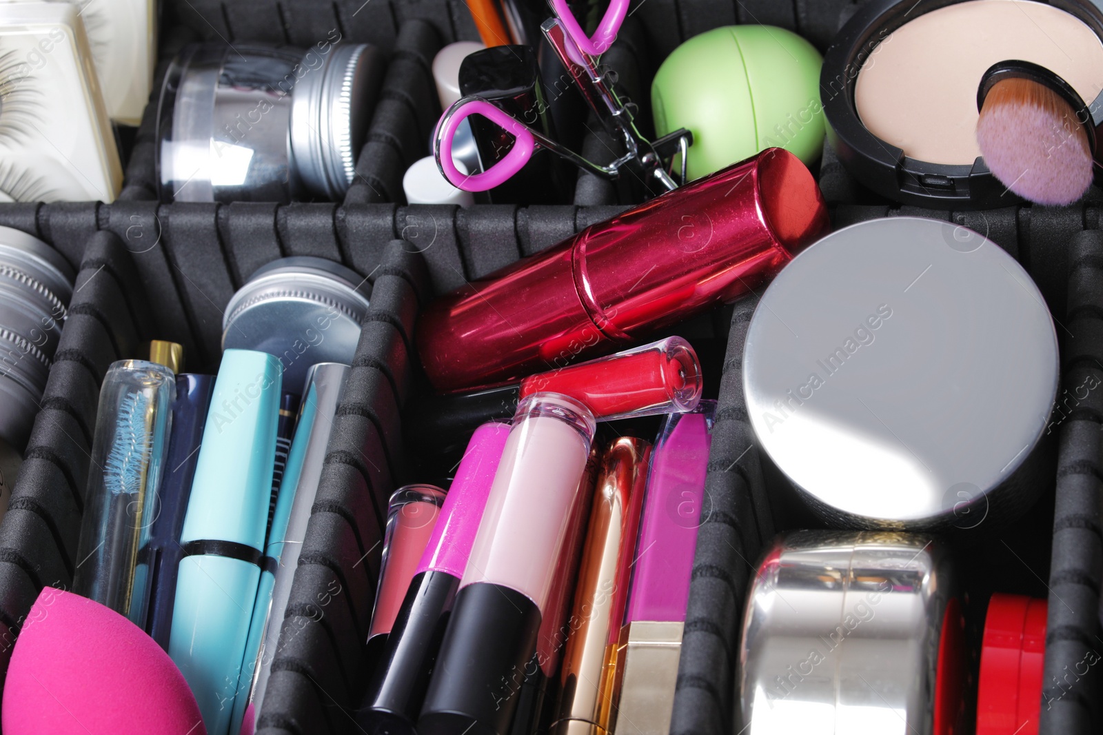 Photo of Stylish case with makeup products and beauty accessories, closeup