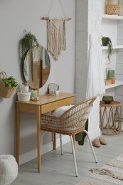 Wooden dressing table with decorative elements in room