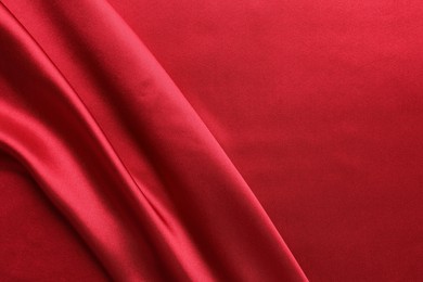 Texture of beautiful red silk fabric as background, closeup