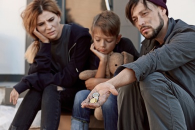 Photo of Poor homeless family begging on city street