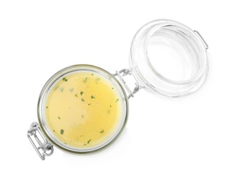 Photo of Jar with lemon sauce on white background, top view. Delicious salad dressing