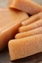 Tasty sweet quince paste on wooden board, closeup