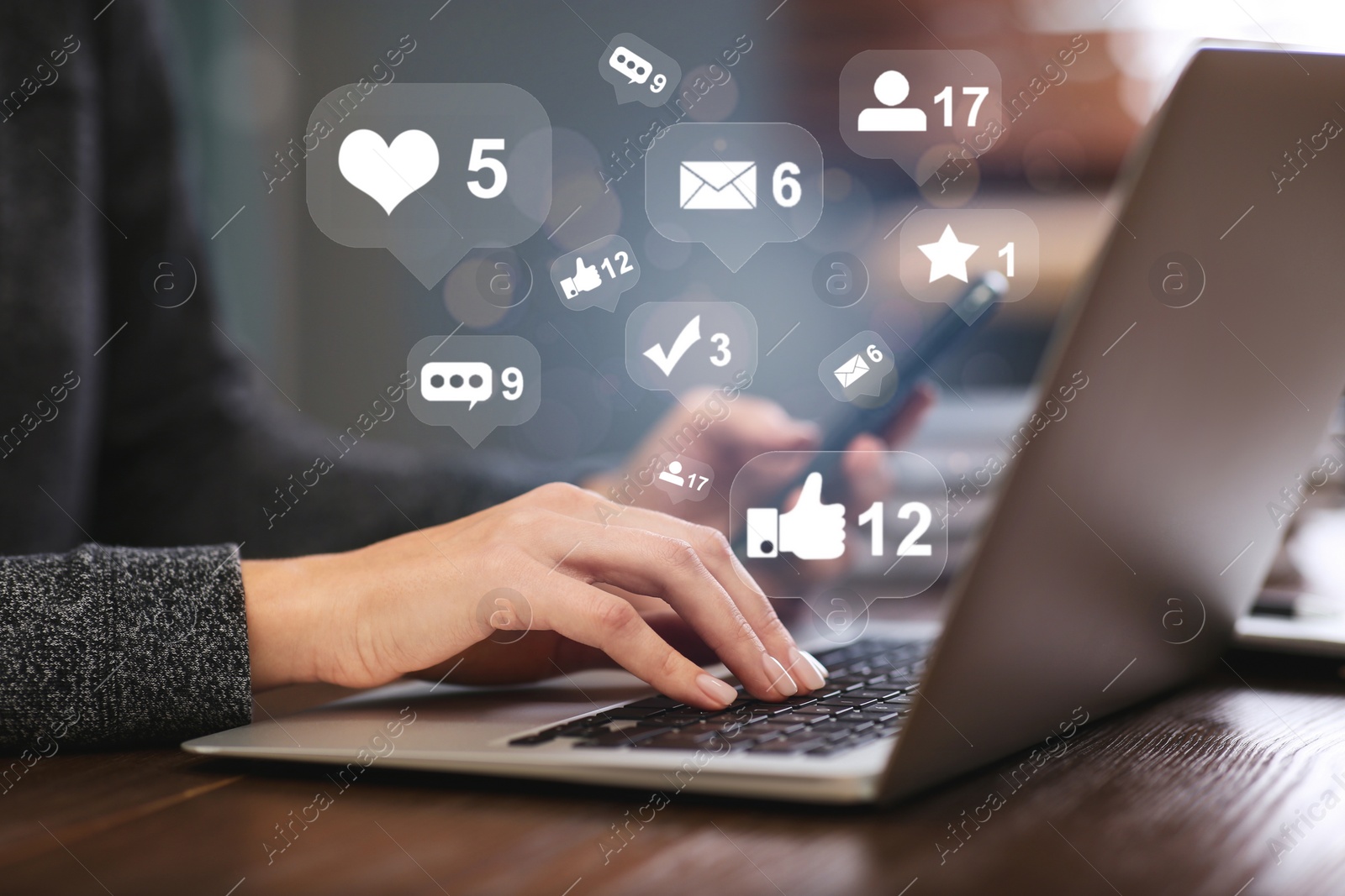 Image of Woman with mobile phone working on modern laptop at table, closeup. Social media marketing