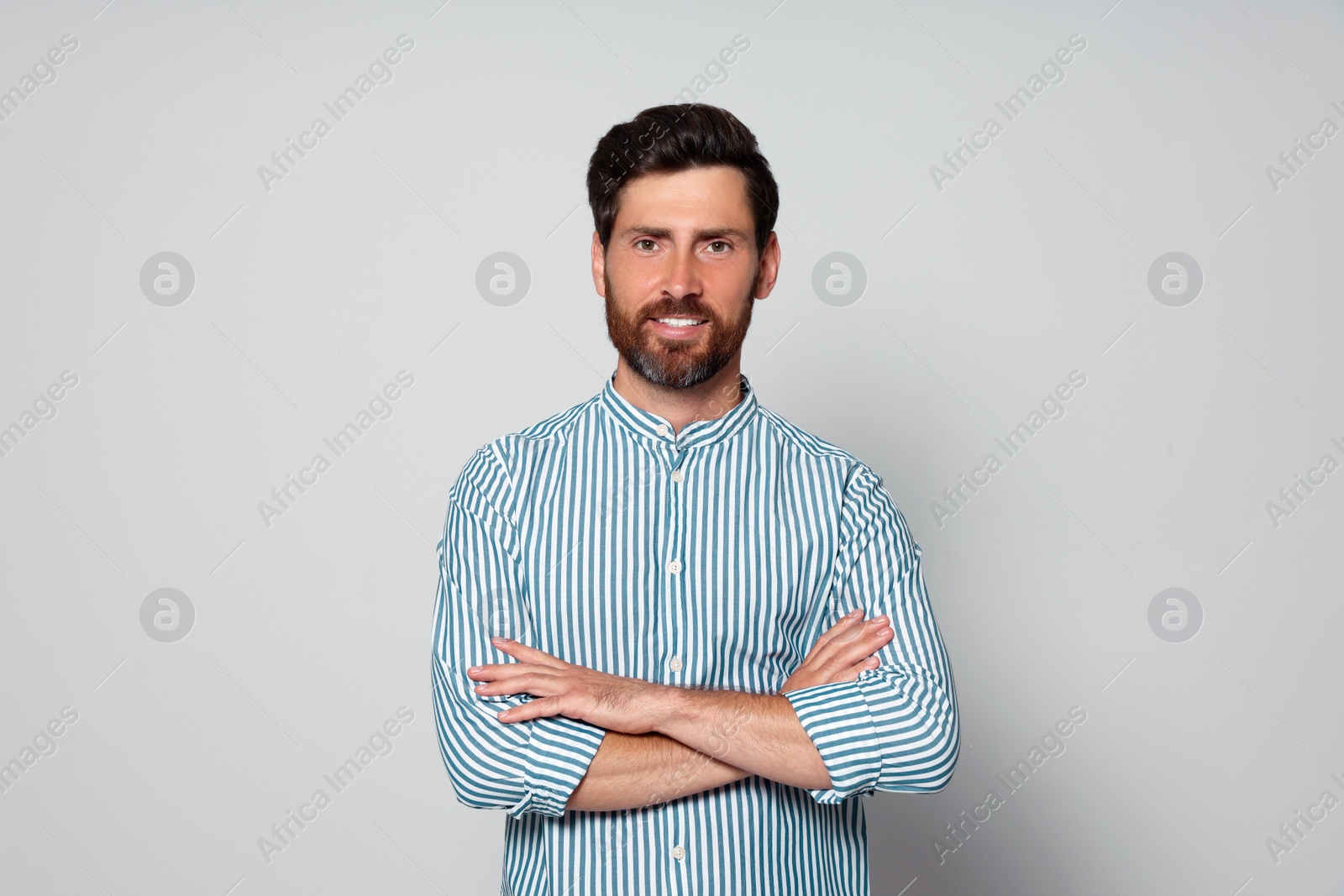 Photo of Portrait of handsome bearded man on grey background