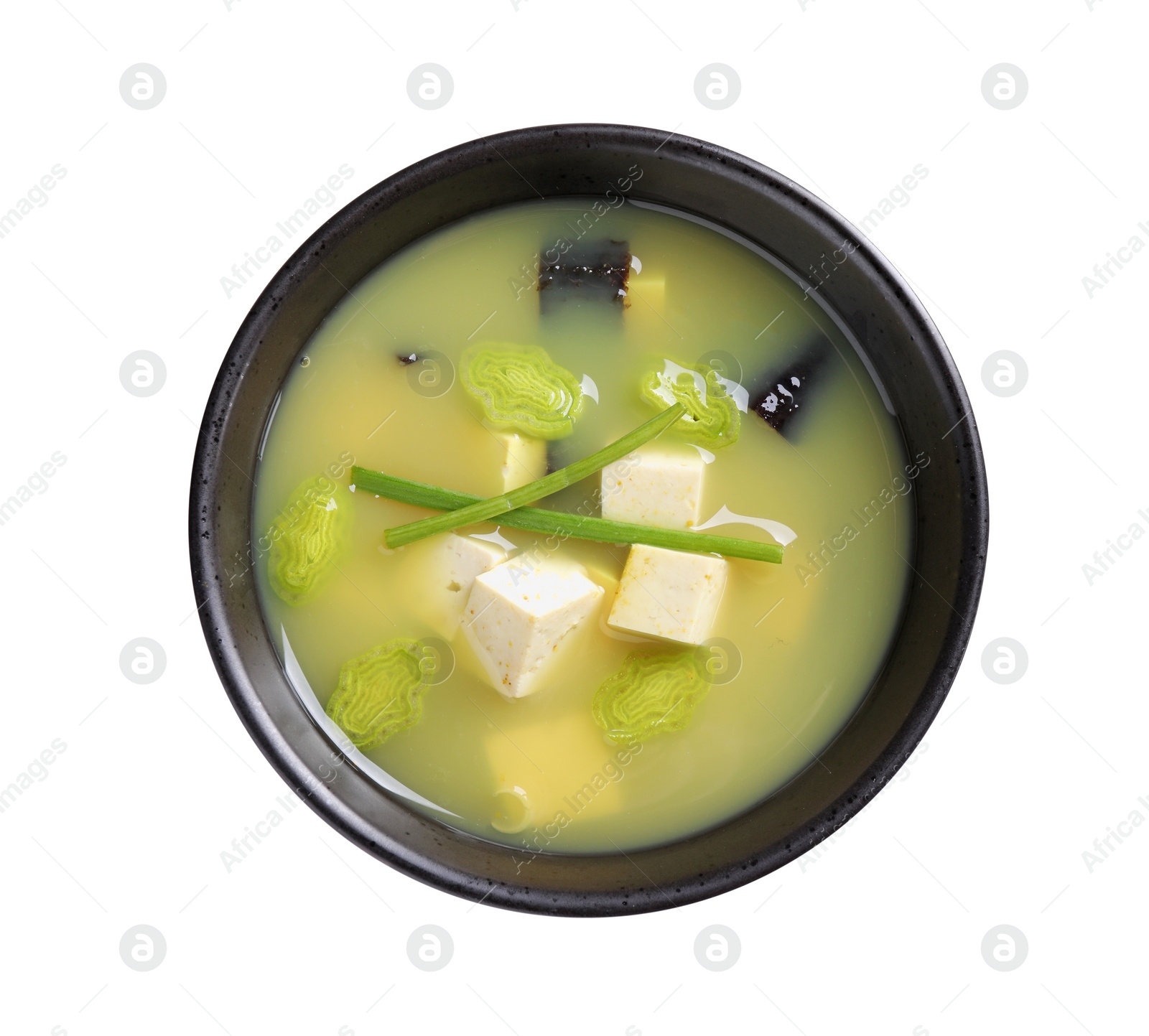 Photo of Bowl of delicious miso soup with tofu isolated on white, top view