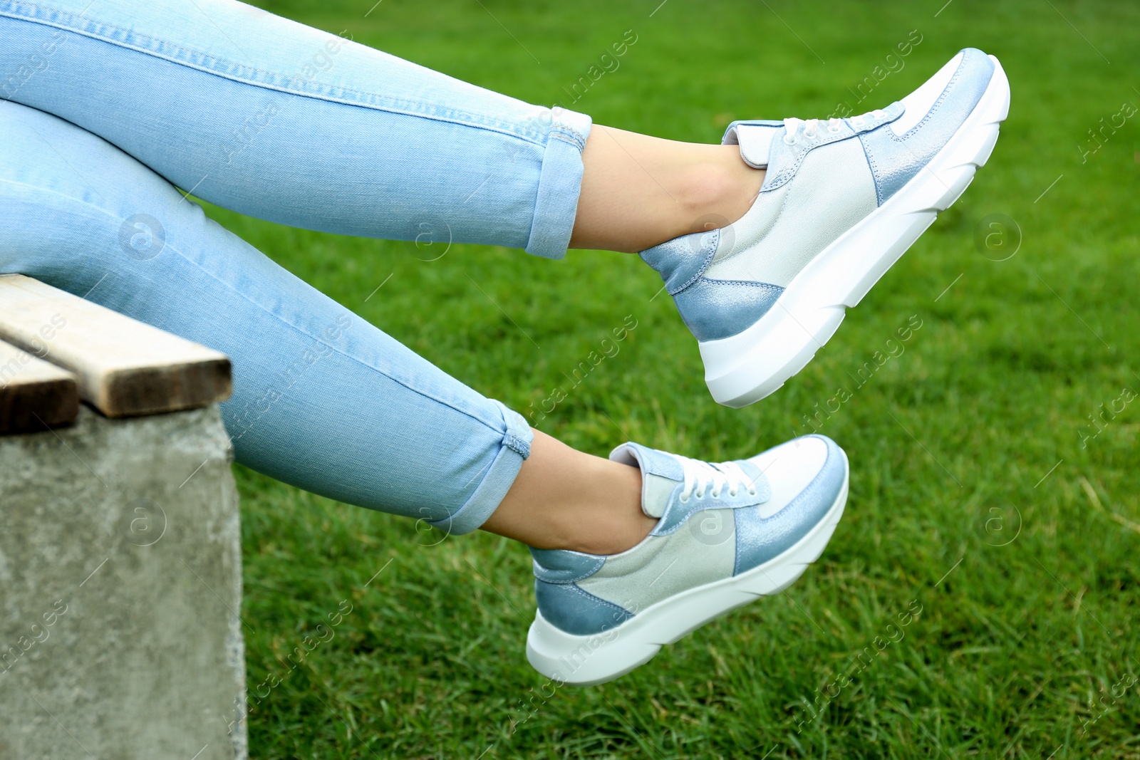 Photo of Woman wearing comfortable stylish sneakers outdoors, closeup