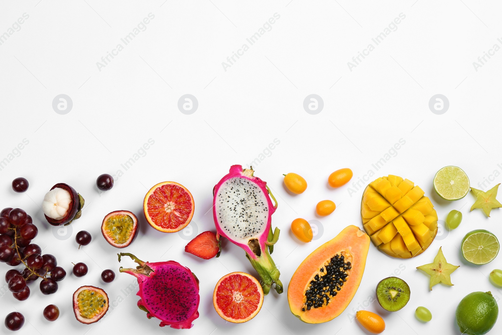 Photo of Many different delicious exotic fruits on white background, flat lay. Space for text