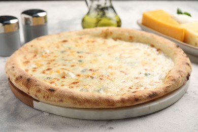 Photo of Delicious cheese pizza on light table, closeup