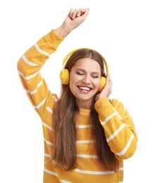 Young woman listening to music with headphones on white background