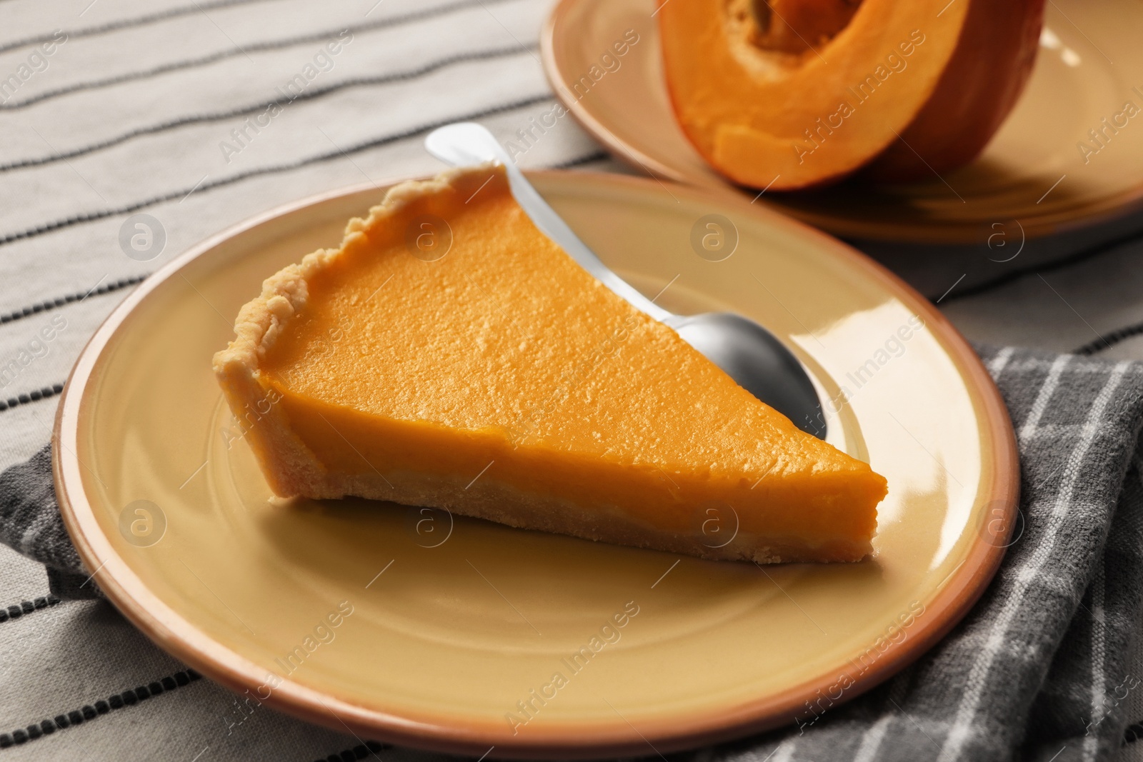 Photo of Plate with piece of fresh homemade pumpkin pie on table