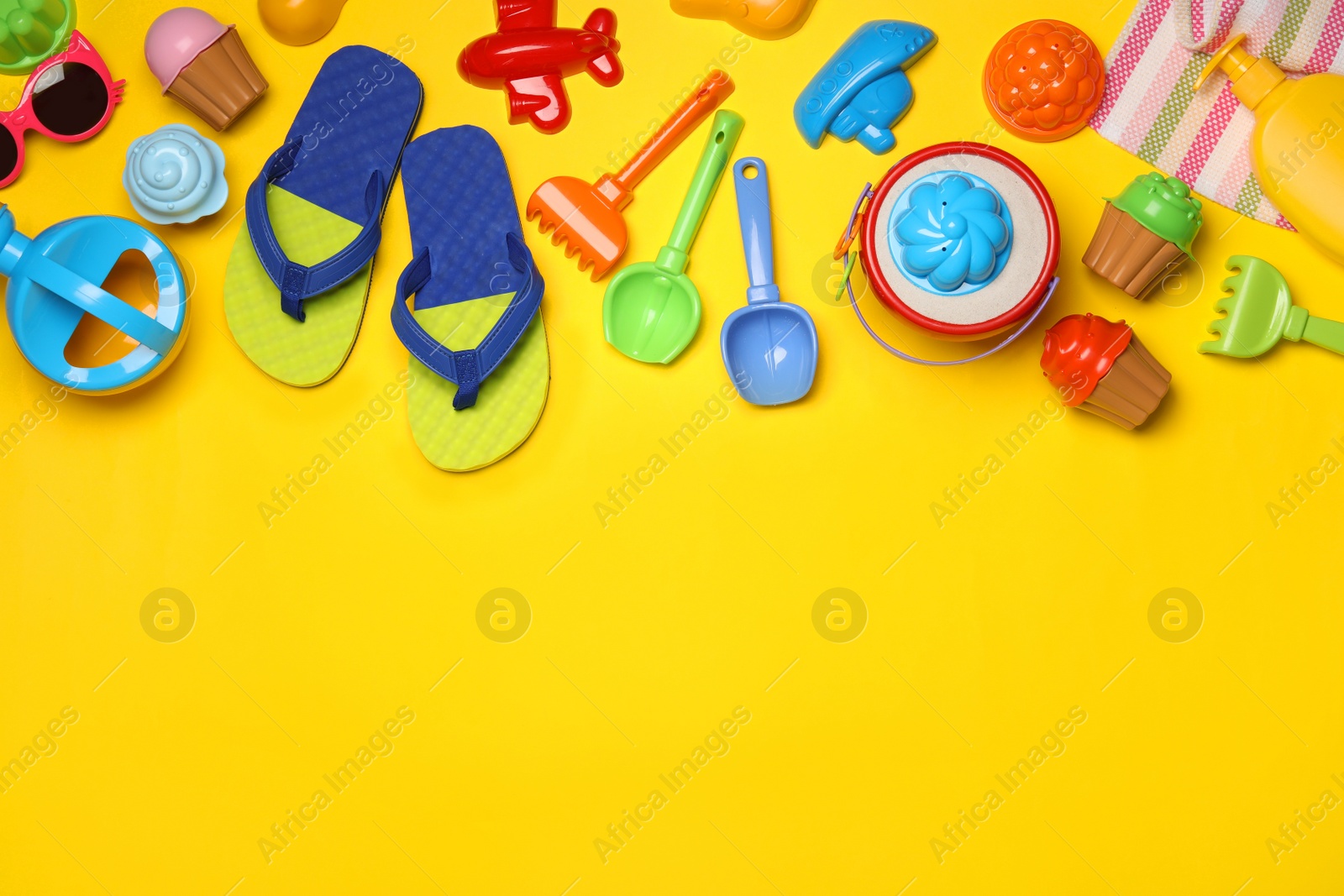 Photo of Flat lay composition with beach toys on color background. Space for text