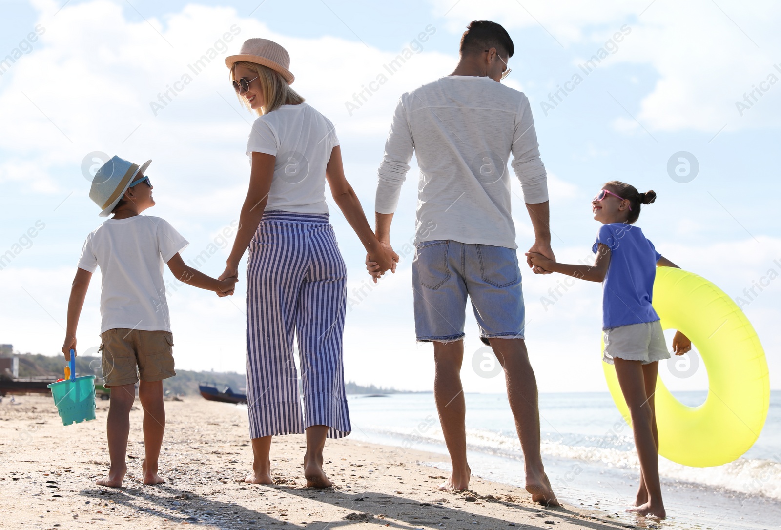 Photo of Happy family at beach on sunny summer day