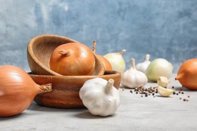 Photo of Composition with garlic bulb and onions on table. Space for text