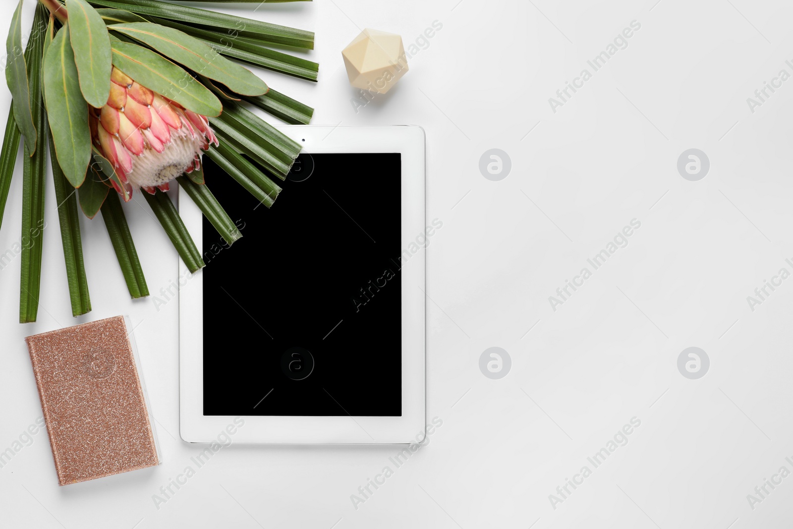 Photo of Creative flat lay composition with tropical flower and tablet on white background