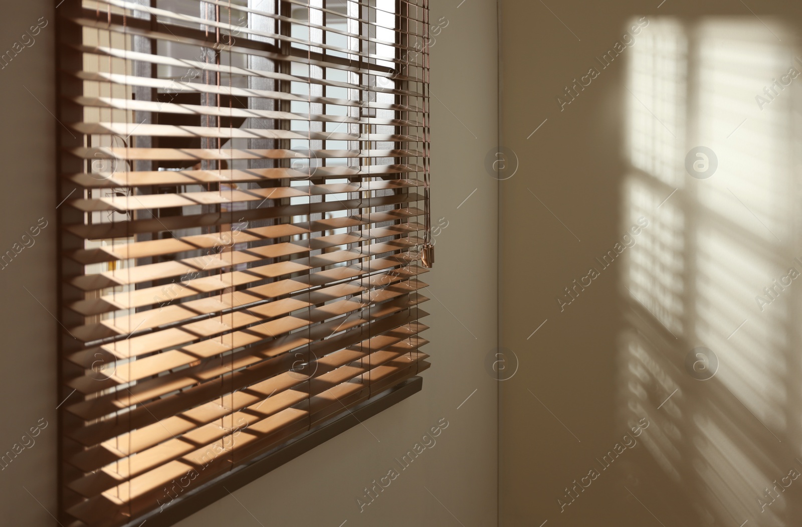 Photo of Window with horizontal blinds in room. Space for text