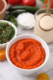 Photo of Fresh homemade marinade in bowl on table, closeup