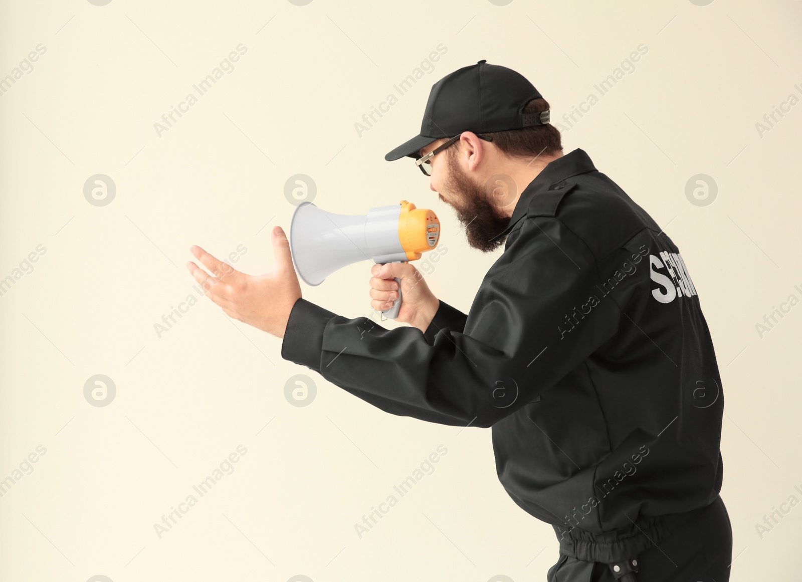 Photo of Security guard shouting into megaphone indoors