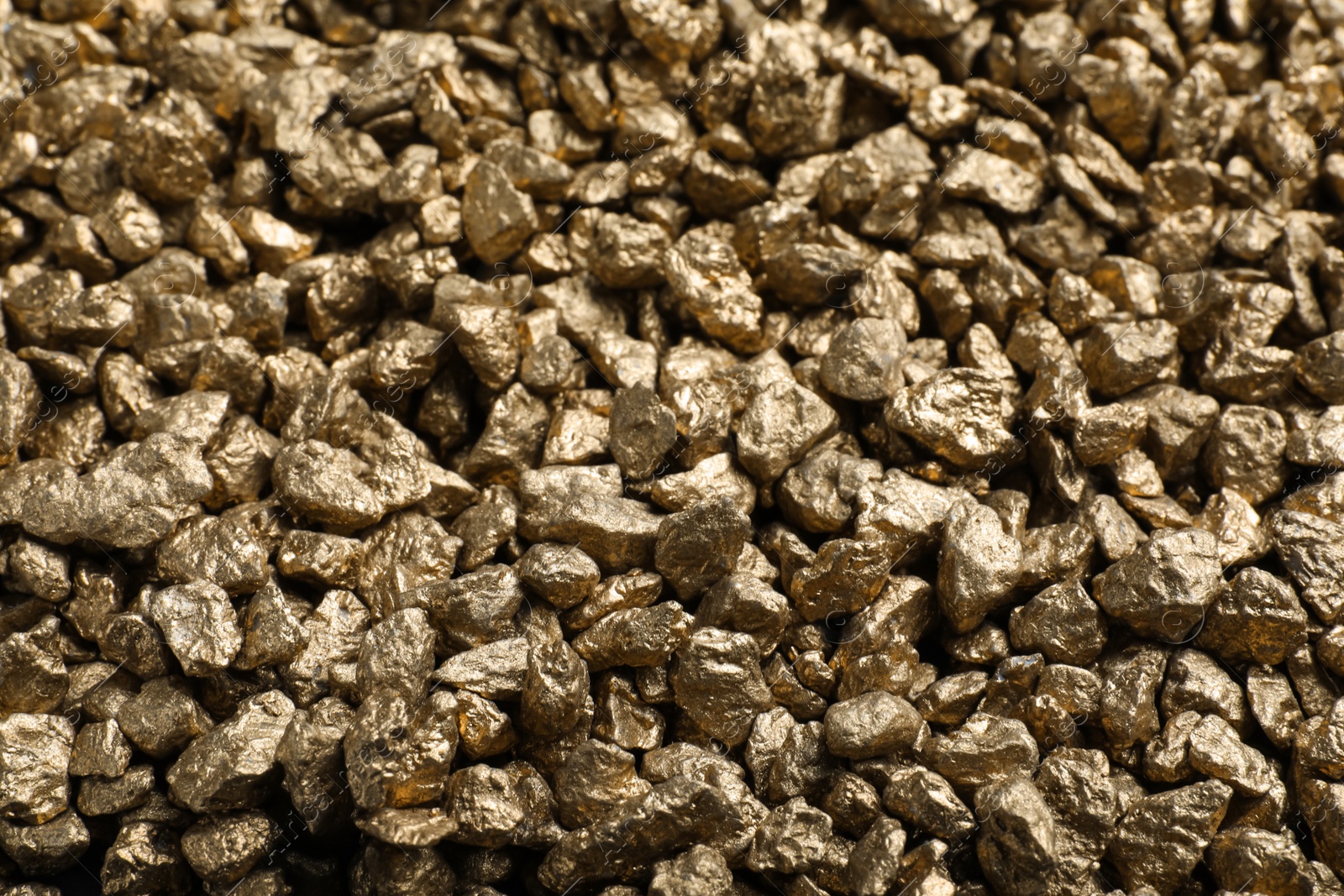 Photo of Pile of gold nuggets as background, closeup