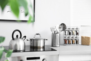 Photo of Modern kitchen interior with new furniture and different utensils