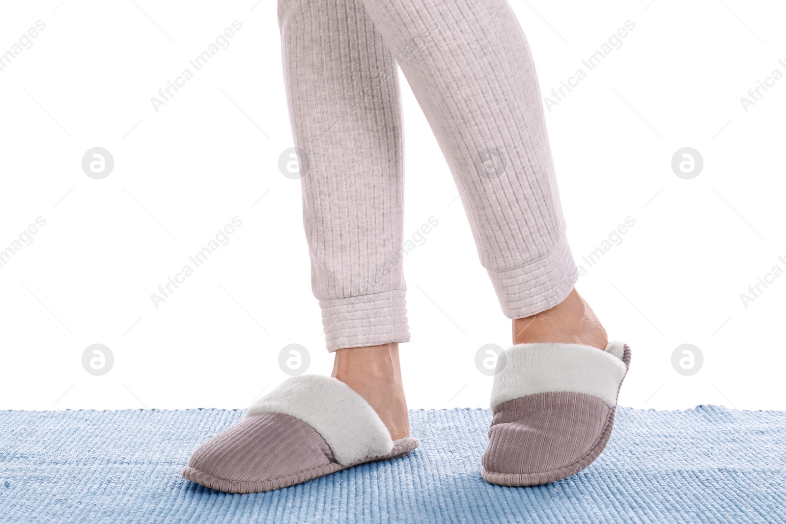 Photo of Woman in warm soft slippers on white background, closeup