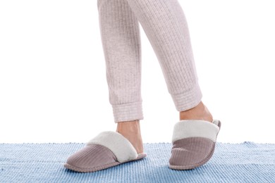 Woman in warm soft slippers on white background, closeup