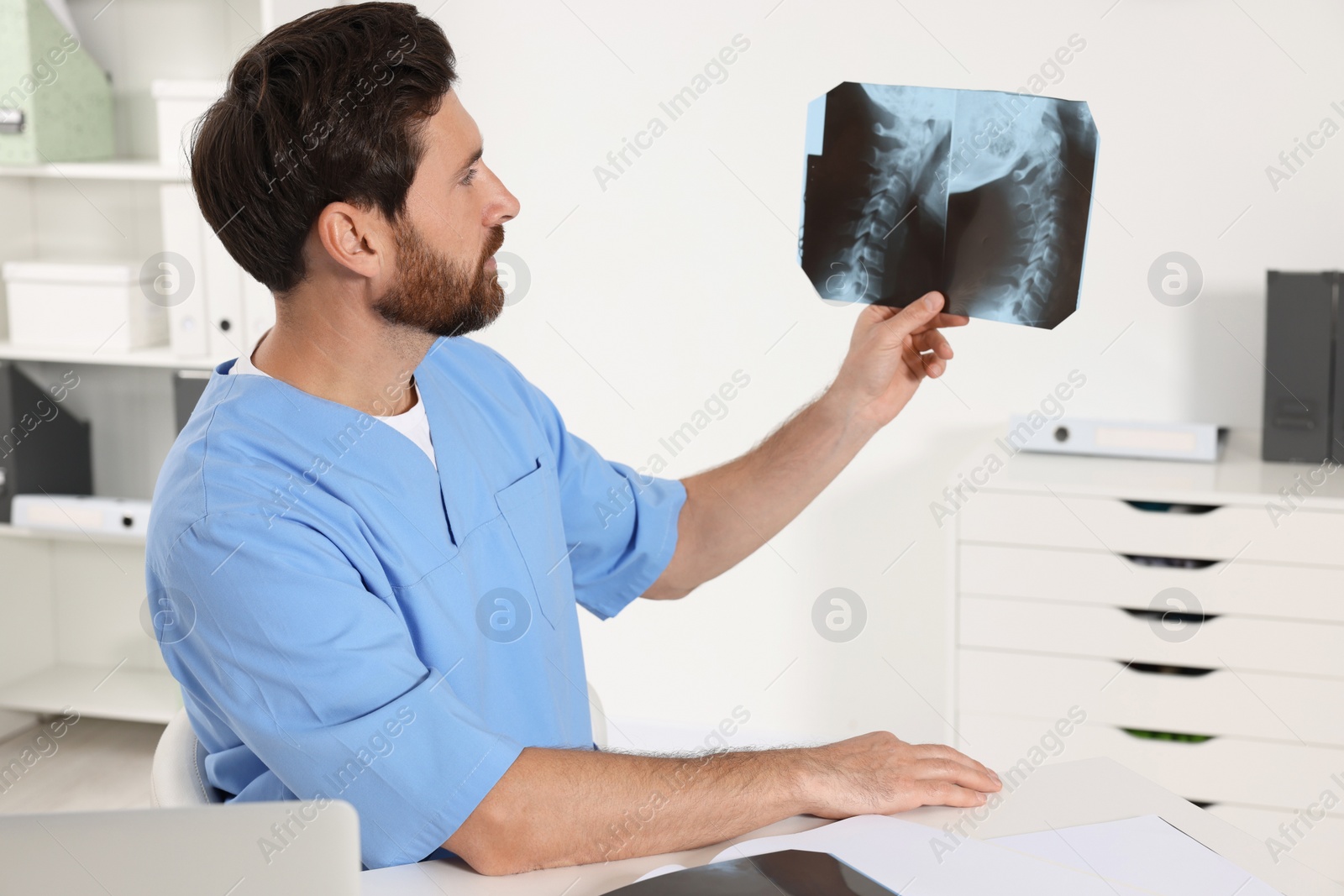 Photo of Doctor examining neck MRI scan in hospital