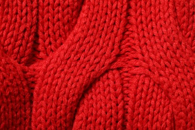 Photo of Texture of soft red knitted fabric as background, top view