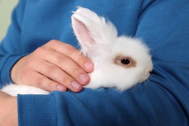 Photo of Man with fluffy white rabbit, closeup. Cute pet