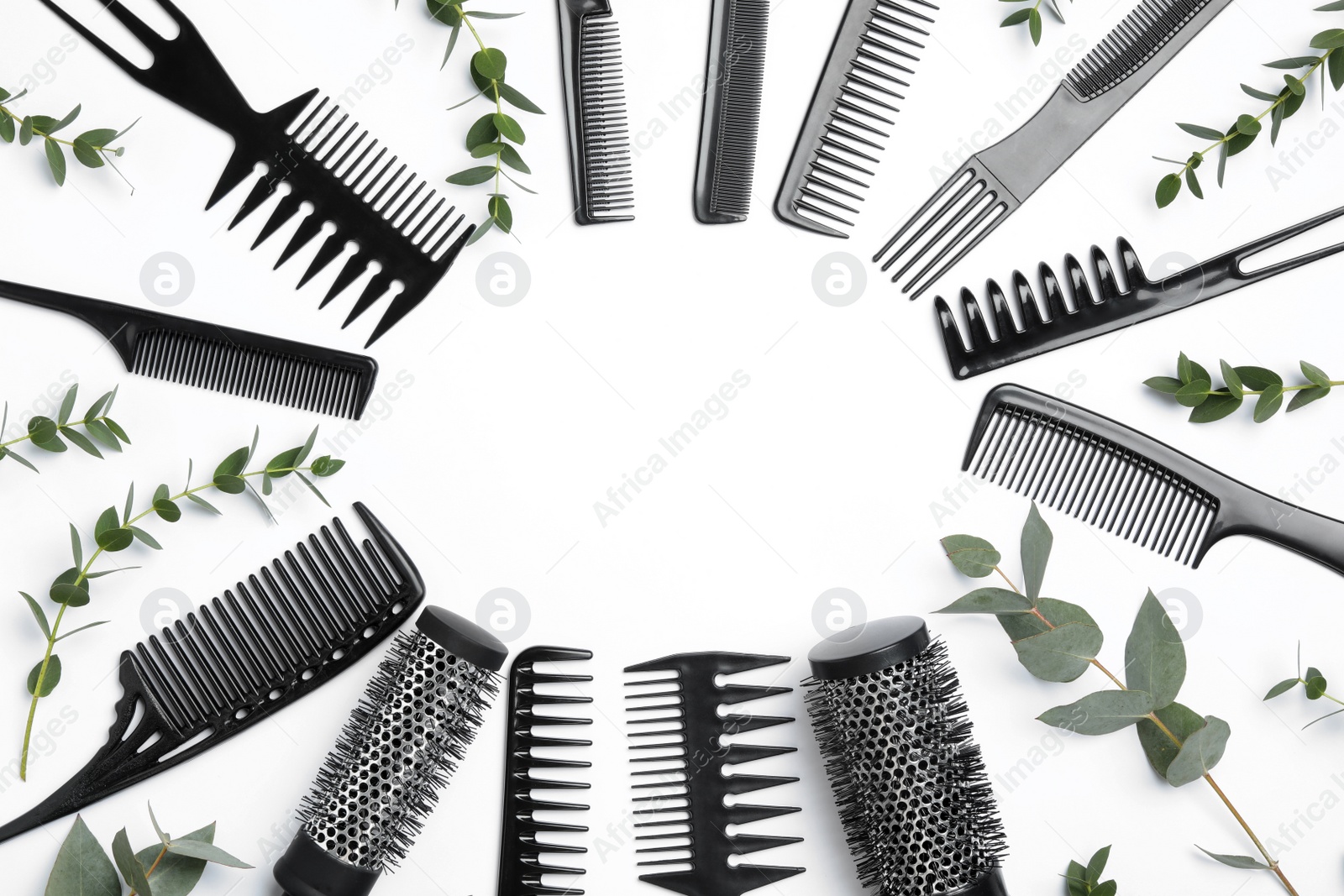 Photo of Frame of hair combs and brushes on white background, top view. Space for text