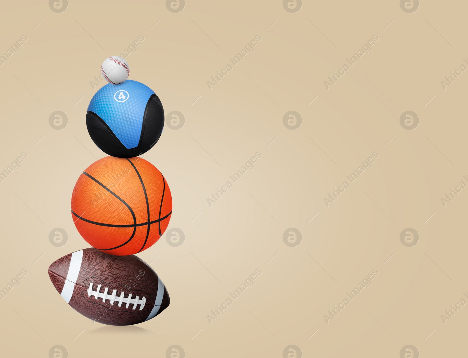 Image of Stack of different sport and medicine balls on beige background, space for text