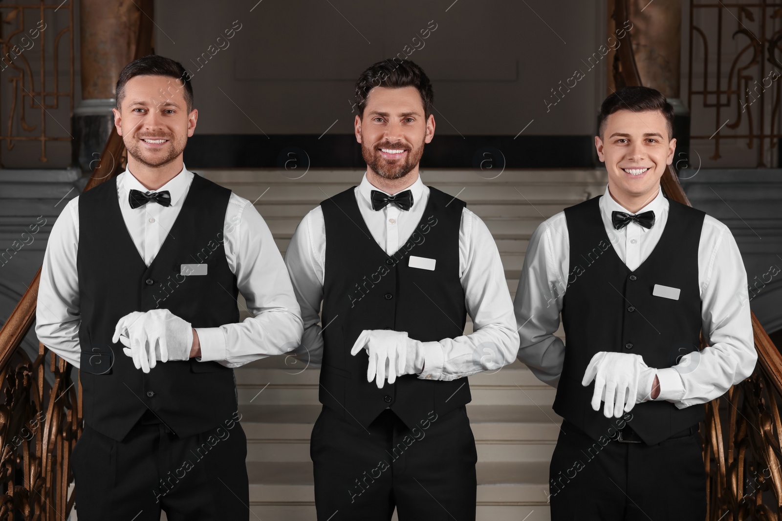 Photo of Group of trainees wearing formal clothes in hotel. Professional butler courses